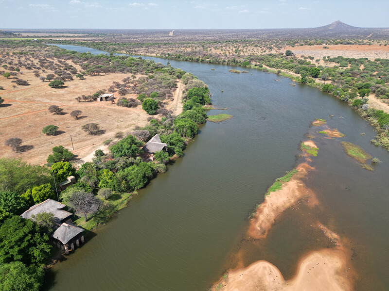 South african river in the middle of the bush and a hunter's lodge