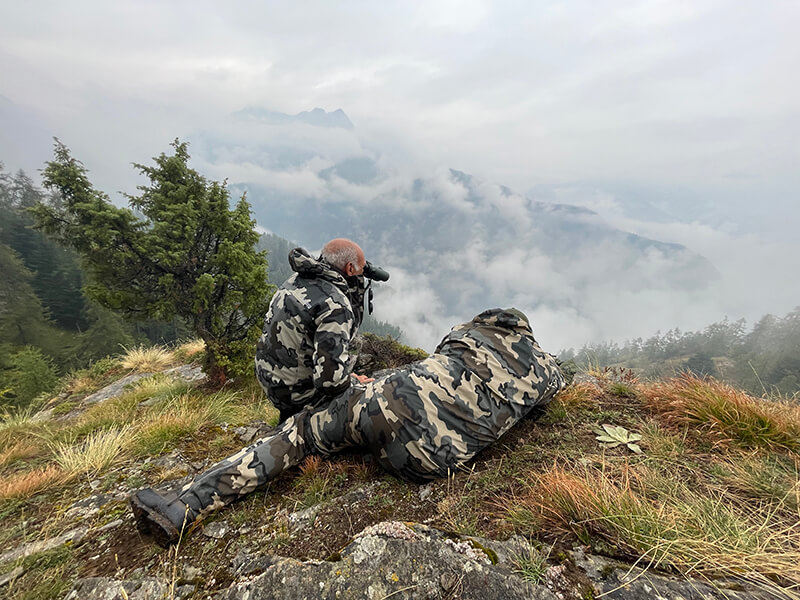 Hunters scanning the horizon looking for chamois in Italian La bianca Hunting estate