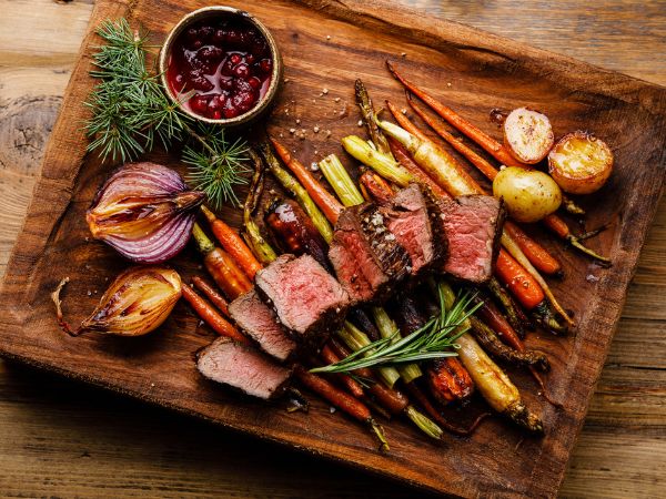 Grilled sliced ​​venison steak with baked vegetables