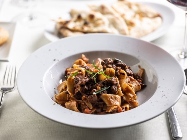 Papardelle with wild boar, a typical Sienese dish with game ragù on a plate.